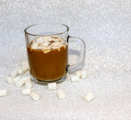 hot delicious coffee with sweet marshmallow air on silver background.