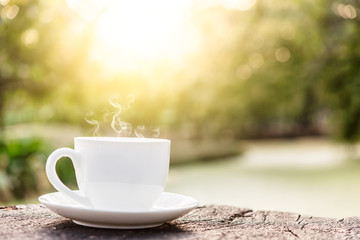 White coffee cup on top wooden table with blurred background, Sunset View