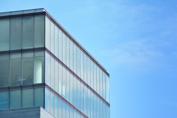 Modern office building with blue sky and clouds