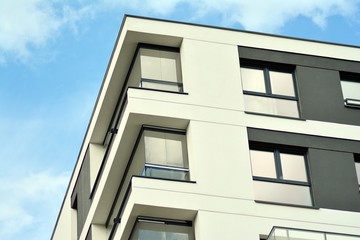 Apartment building with blue sky and clouds