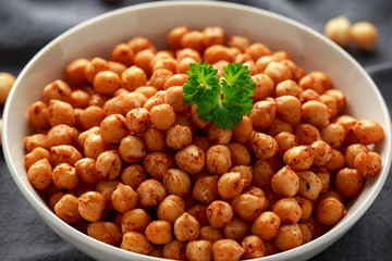 Roasted spicy chickpeas in white bowl. Healthy food