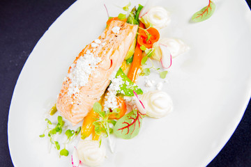 Grilled salmon with wasabi mashed potatoes, vegetables and lemon powder