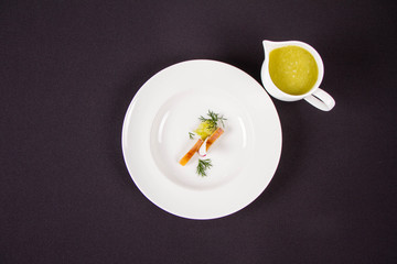 Fresh cucumber borsch with smoked cod served in a jug