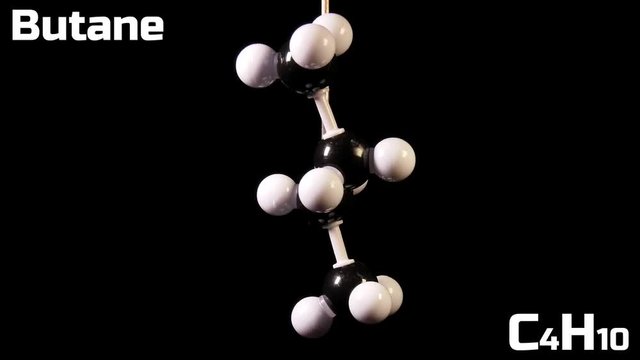 Butane C4H10 molecule rotating on black background