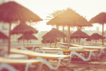 Beach umbrellas on the the beautiful beach in Morocco. Selective focus.