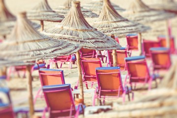 Beach umbrellas on the the beautiful beach in Morocco. Selective focus.