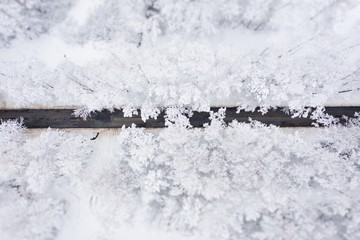 Aerial view of winter beautiful landscape road with trees covered with hoarfrost and snow. Winter scenery from above. Landscape photo captured with drone.