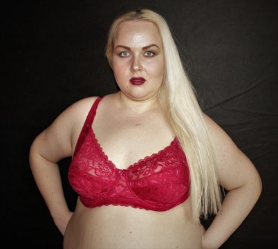 Beautiful plump blonde in red underwear posing for the camera. Obesity problems close up.