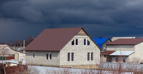 Black clouds over the house in the village