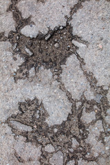 Cracks and pit on the asphalt road as background
