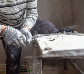 Worker cuts with a knife drywall repair