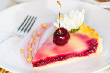 A piece of cake on a served table with tea