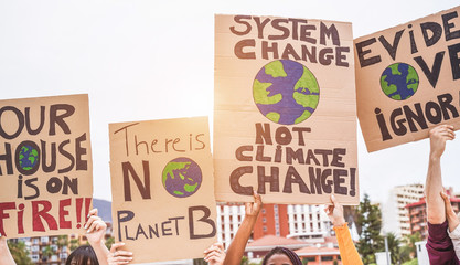 Group of demonstrators on road, young people from different culture and race fight for climate change - Global warming and enviroment concept - Focus on banners - obrazy, fototapety, plakaty