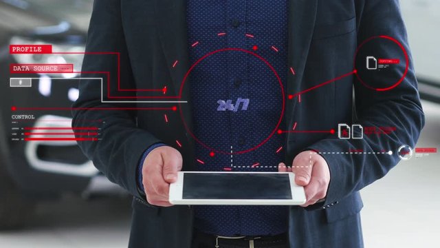 Man with a futuristic screen with the word 24/7. The concept of the future interface on a transparent display