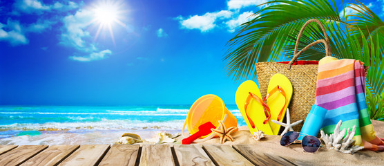 Tropical beach with sunbathing accessories, summer holiday background - obrazy, fototapety, plakaty