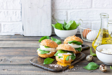 Veggie burger with poached egg and sorrel in a curd bun on rice flour