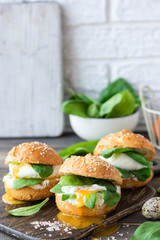 Veggie burger with poached egg and sorrel in a curd bun on rice flour