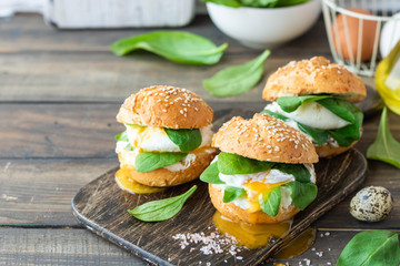 Veggie burger with poached egg and sorrel in a curd bun on rice flour
