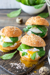 Veggie burger with poached egg and sorrel in a curd bun on rice flour