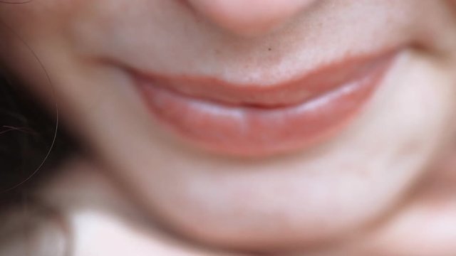 Very closeup of womans lips shallow DOF