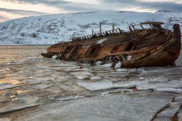 Old rusty fishing boat in winter