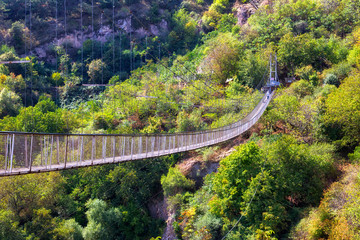 Fototapeta na wymiar Suspension bridge over the gorge leading to Khndzoresk cave settlement, Syunik region, Armenia