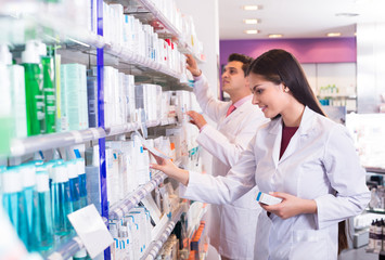 Pharmacist and pharmacy technician posing