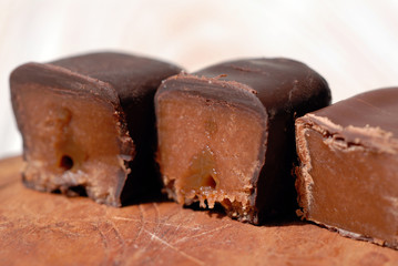 Chocolate candies on a wooden stand closeup. Shallow depth of field