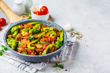 Fried beef stroganoff with potatoes and vegetables in a pan.