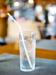 Glass of cold water blurred, placed on the dining table