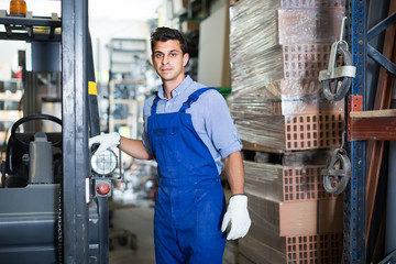 Portrait of calm male in uniform on his workplace in building store.