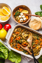 Vegan lentil curry with vegetables, top view. Healthy plant based food background.