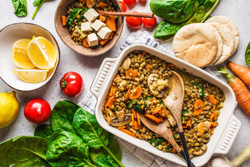 Vegan lentil curry with vegetables, top view. Healthy plant based food background.