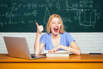 Female university student on campus. College tutor. Student working on laptop in college. Student help homework.