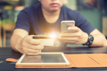Close up of businessman hand using laptop and mobile phone in morning light