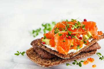 Salted salmon, red caviar, avocado and cream cheese rye crisp toast