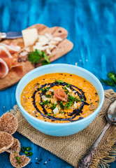 Pumpkin cream soup bowl, served with sesame,  prosciutto, parmesan cheese, olive oil, balsamic and herbs