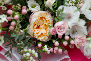 Part of a large beautiful bouquet of various bright flowers in a bright pink wrapper