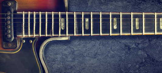 Old jazz electro guitar on a dark background. Close up. Copy space. Background for music festivals, concerts. Music background.