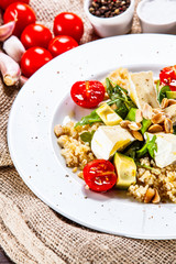 Salad with avocado and cheese on wooden background