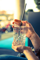 Refreshing drink in the summer: Girl is holding glass with cold beverage