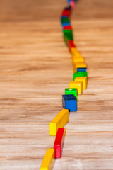 Track of dominoes on a wooden floor home