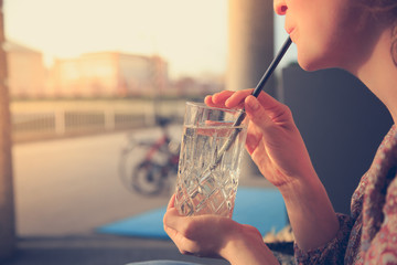 Refreshing drink in the summer: Girl is holding glass with cold beverage