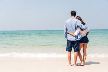 Romantic lovers young couple relaxing together on the tropical beach.Man hugging with woman and enjoy life.Summer vacations