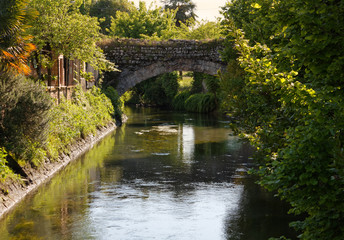 Fototapeta na wymiar Ancient Bridge over a Canal in Aquileia, Italy