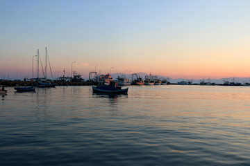 Obraz premium Sunset in the port of Nea Michaniona, suburb of Thessaloniki, Greece. View of the ships. 