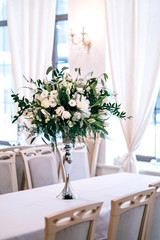 wedding decor, accessories, orchids, roses, eucalyptus, a bouquet in a restaurant, chairs table setting