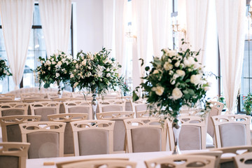 wedding decor, accessories, orchids, roses, eucalyptus, a bouquet in a restaurant, chairs table setting