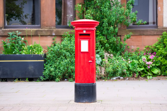 Traditional old red post box for mail and delivery of letters