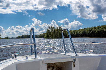 Obraz premium View to lake landscape from motor boat with details of boat